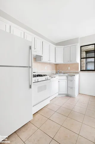 a kitchen with cabinets and white appliances