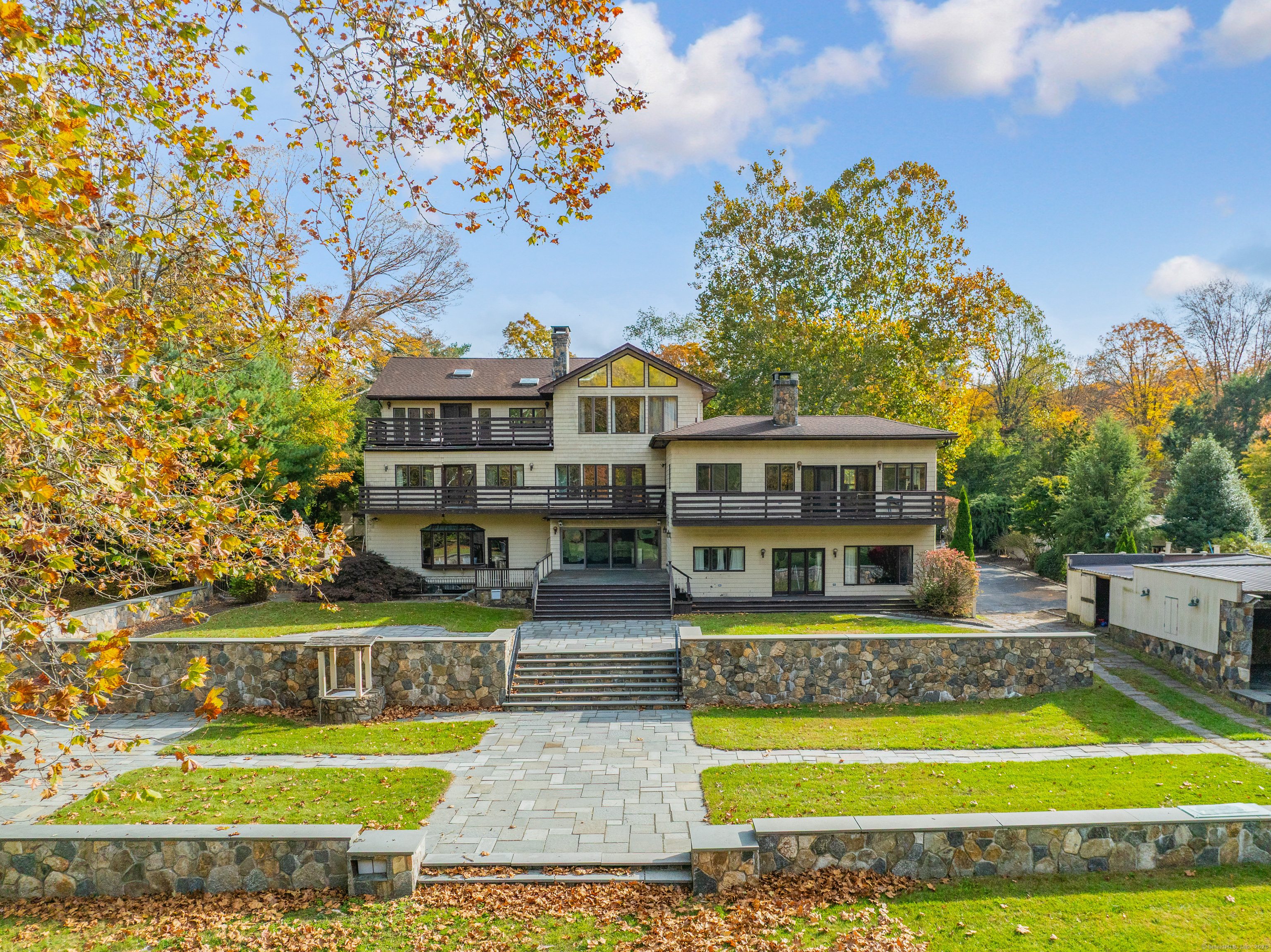 262 Lyons Plain Road Weston, CT 06883 - Photo 1 of 14 a view of swimming pool with outdoor seating and trees in the background