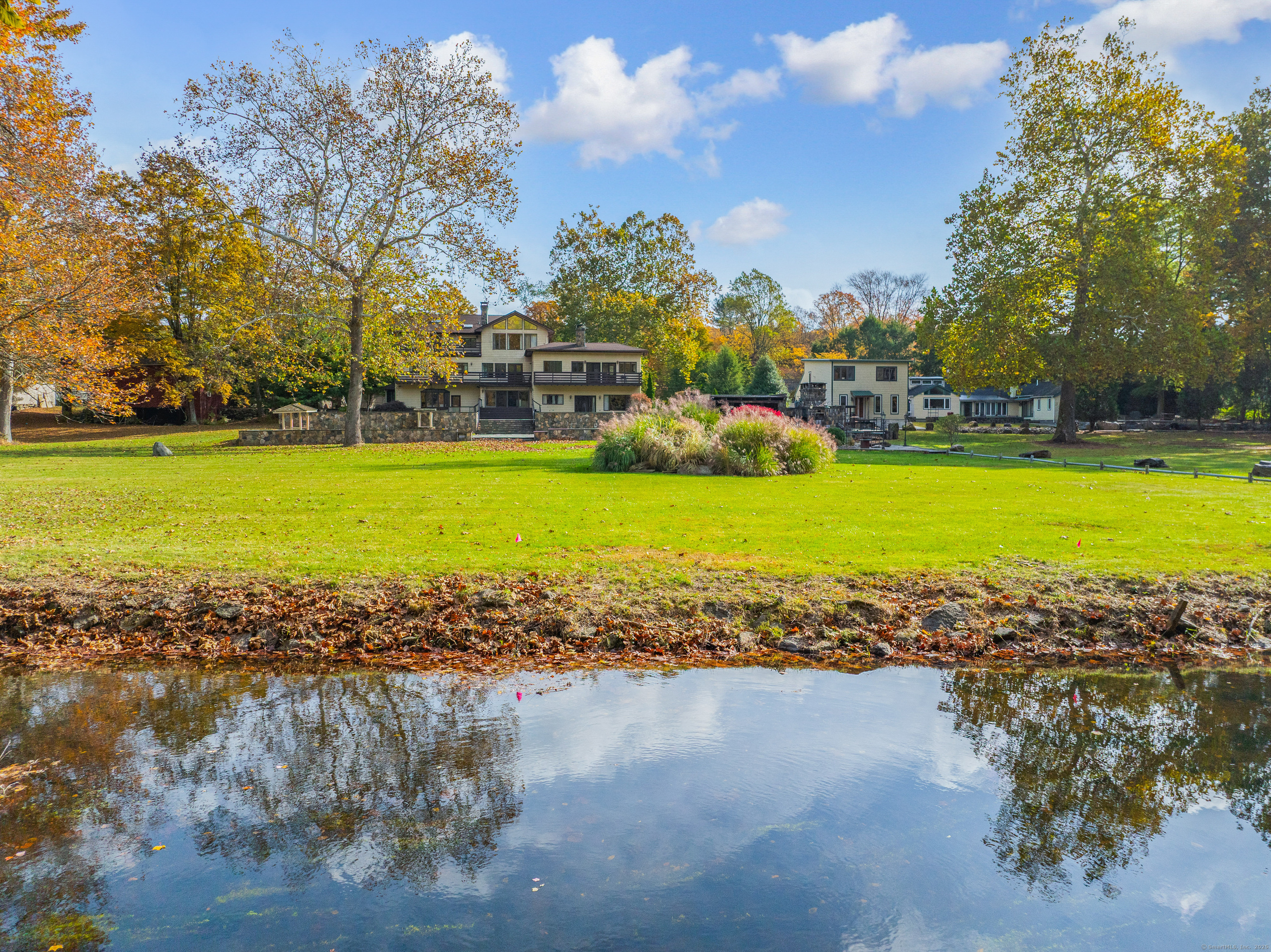 262 Lyons Plain Road Weston, CT 06883 - Photo 6 of 14 a view of a lake with a big yard