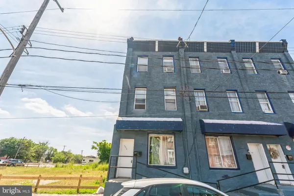 a front view of a building with a yard