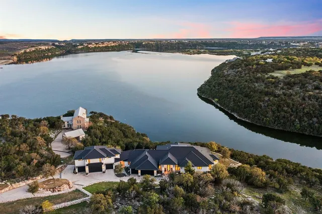 an aerial view of a house with a lake view
