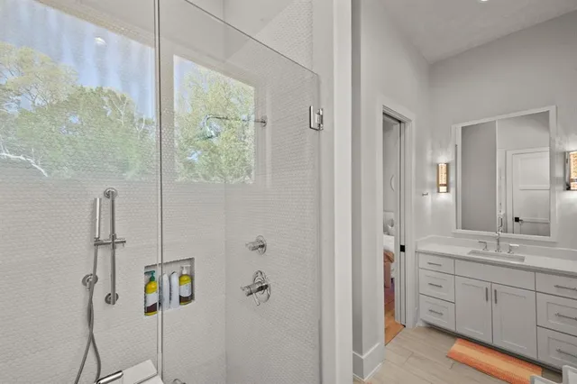 a bathroom with a double vanity sink a mirror and a shower