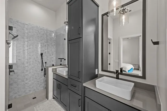 a large bedroom with bed and wooden floor