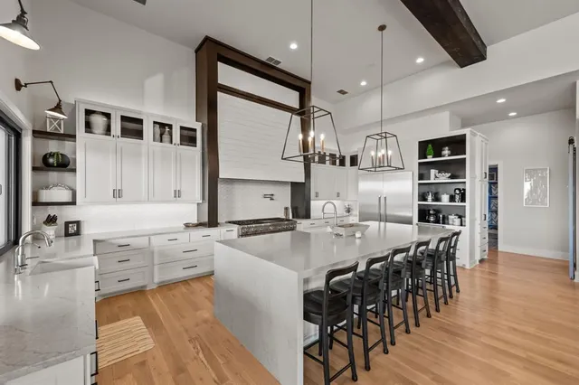 a kitchen with stainless steel appliances kitchen island granite countertop a sink and cabinets