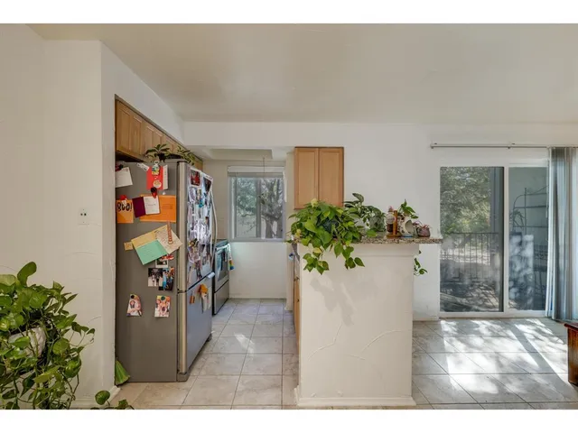 a kitchen with kitchen island granite countertop a sink and a window