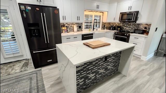 2672 Gulfview Drive Naples, FL 34112 - Photo 7 of 13 a kitchen with stainless steel appliances a refrigerator stove and microwave