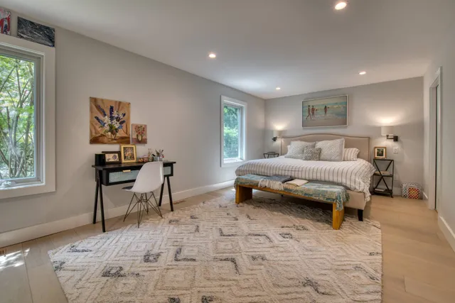 a bedroom with a bed and a desk