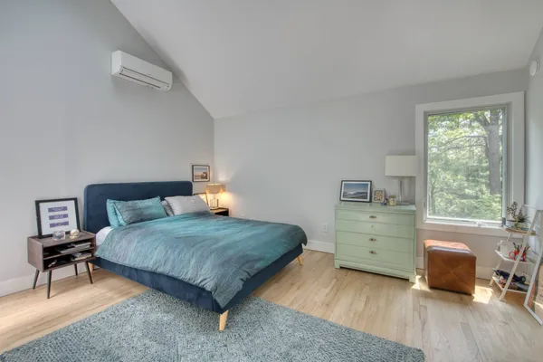 a bedroom with a bed and a window