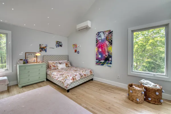 a bedroom with bed and a window