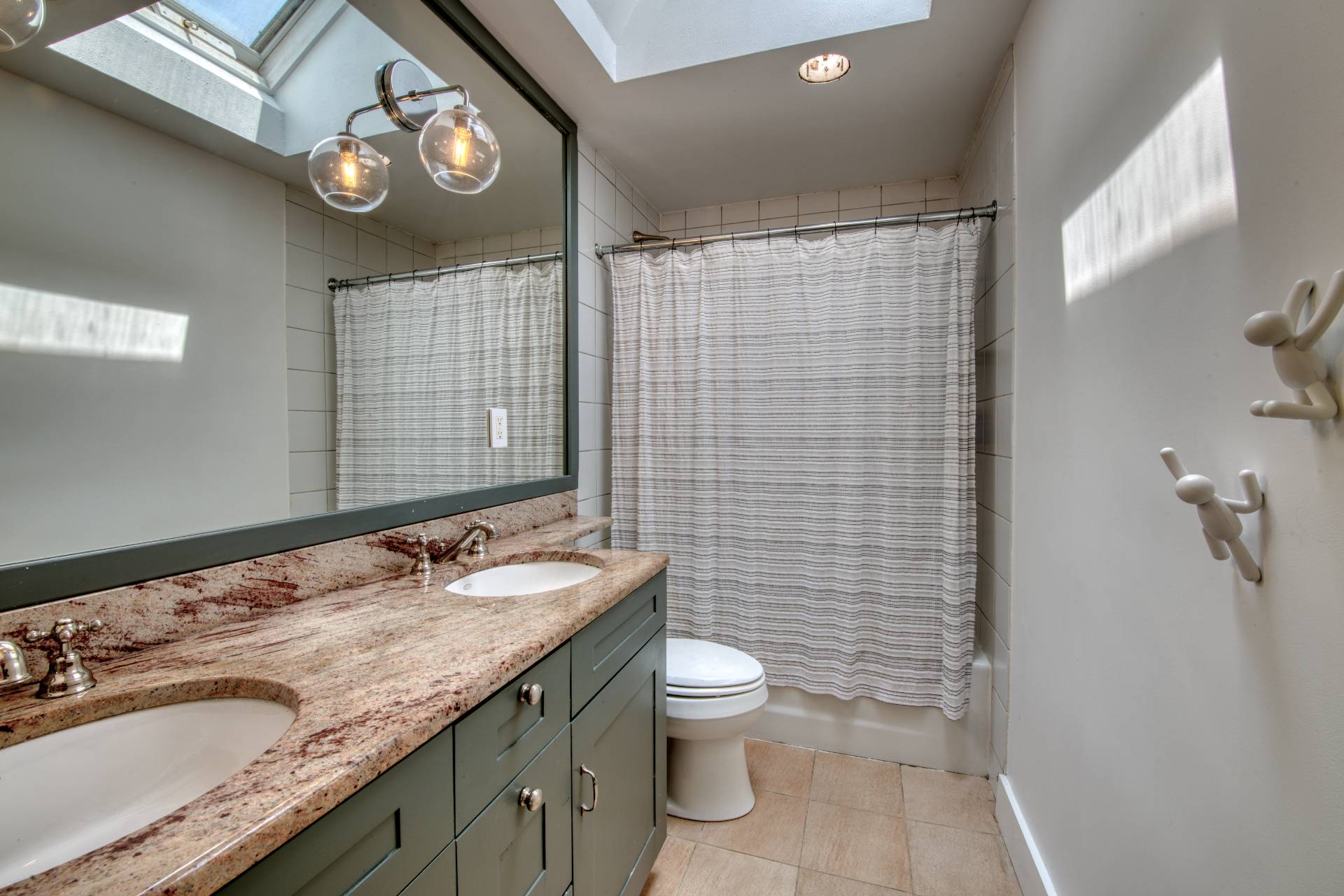 12 Deep View Court East Hampton, NY 11937 - Photo 17 of 20 a bathroom with a granite countertop toilet a sink a mirror and shower curtain