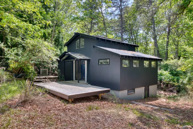 a backyard of a house with table and chairs