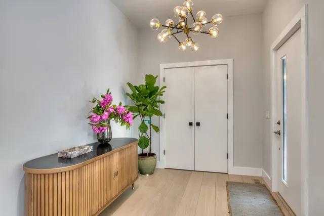 a view of a hallway to dining room with wooden floor