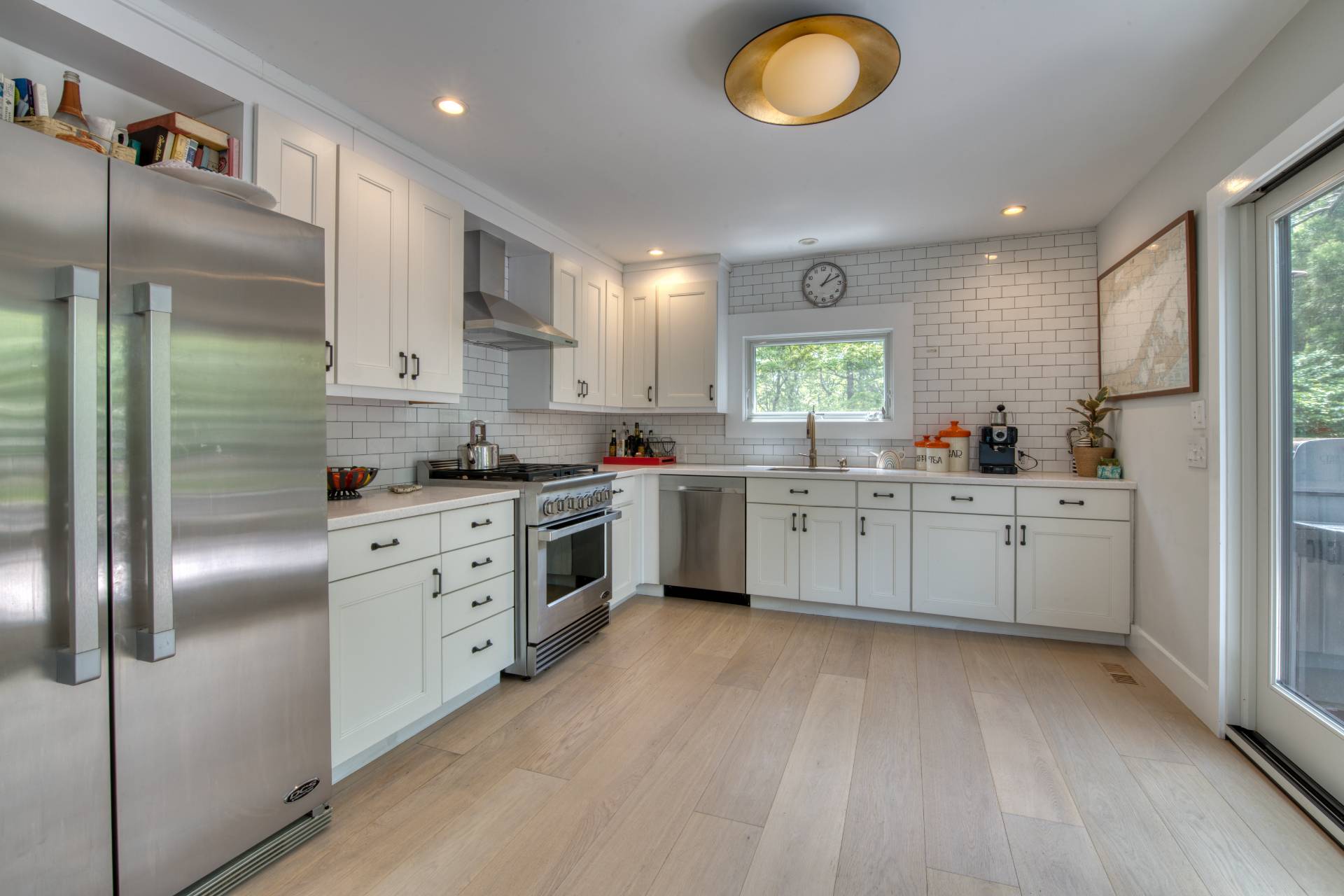 12 Deep View Court East Hampton, NY 11937 - Photo 6 of 20 a kitchen with white cabinets and white appliances