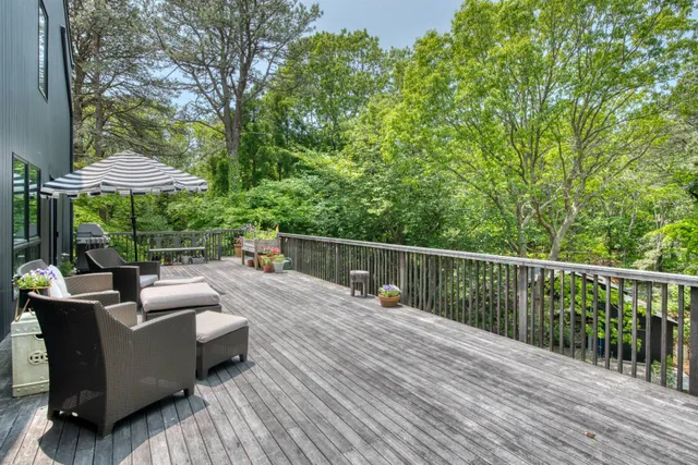 a view of a deck with furniture and wooden floor