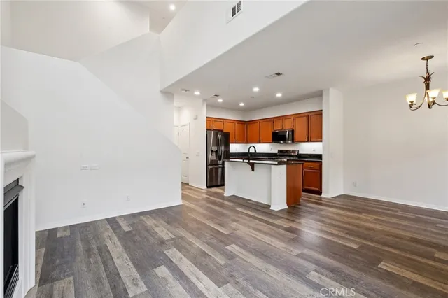 a kitchen with stainless steel appliances granite countertop a stove and a sink