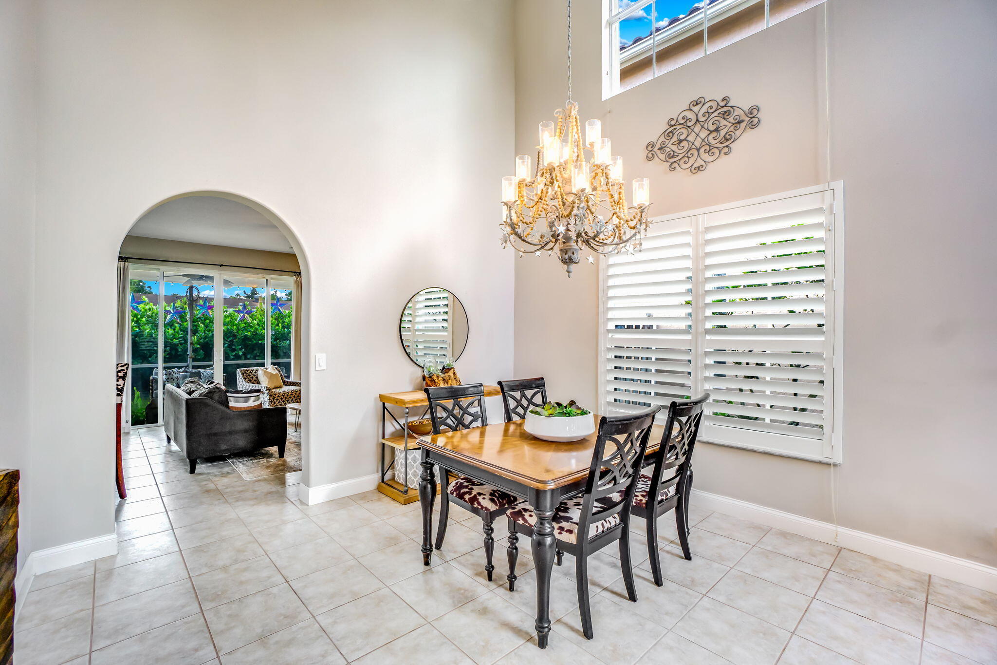 9760 Vineyard Court Boca Raton, FL 33428 - Photo 12 of 75 a dining room with furniture a chandelier and a rug