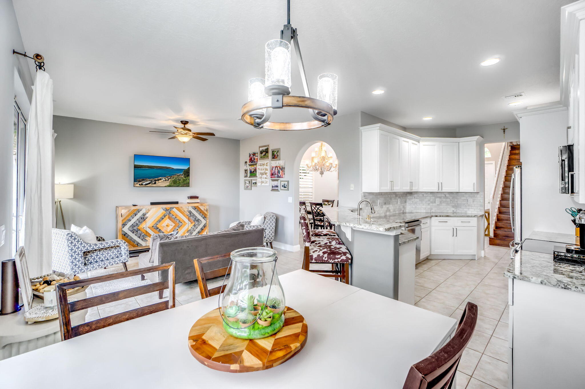 9760 Vineyard Court Boca Raton, FL 33428 - Photo 20 of 75 a living room with kitchen island furniture and a chandelier