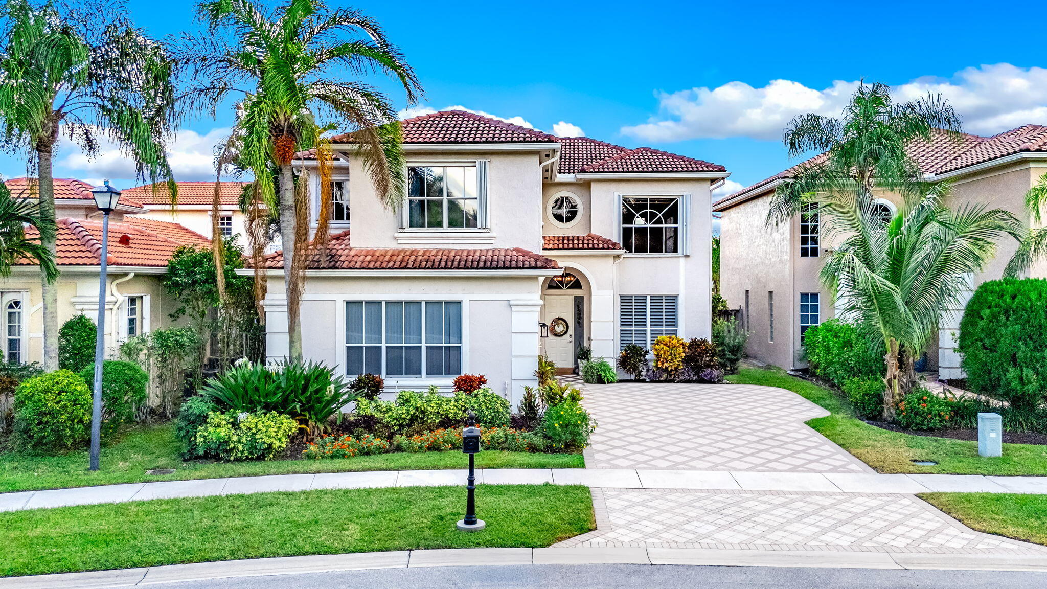 9760 Vineyard Court Boca Raton, FL 33428 - Photo 2 of 75 a front view of a house with a yard