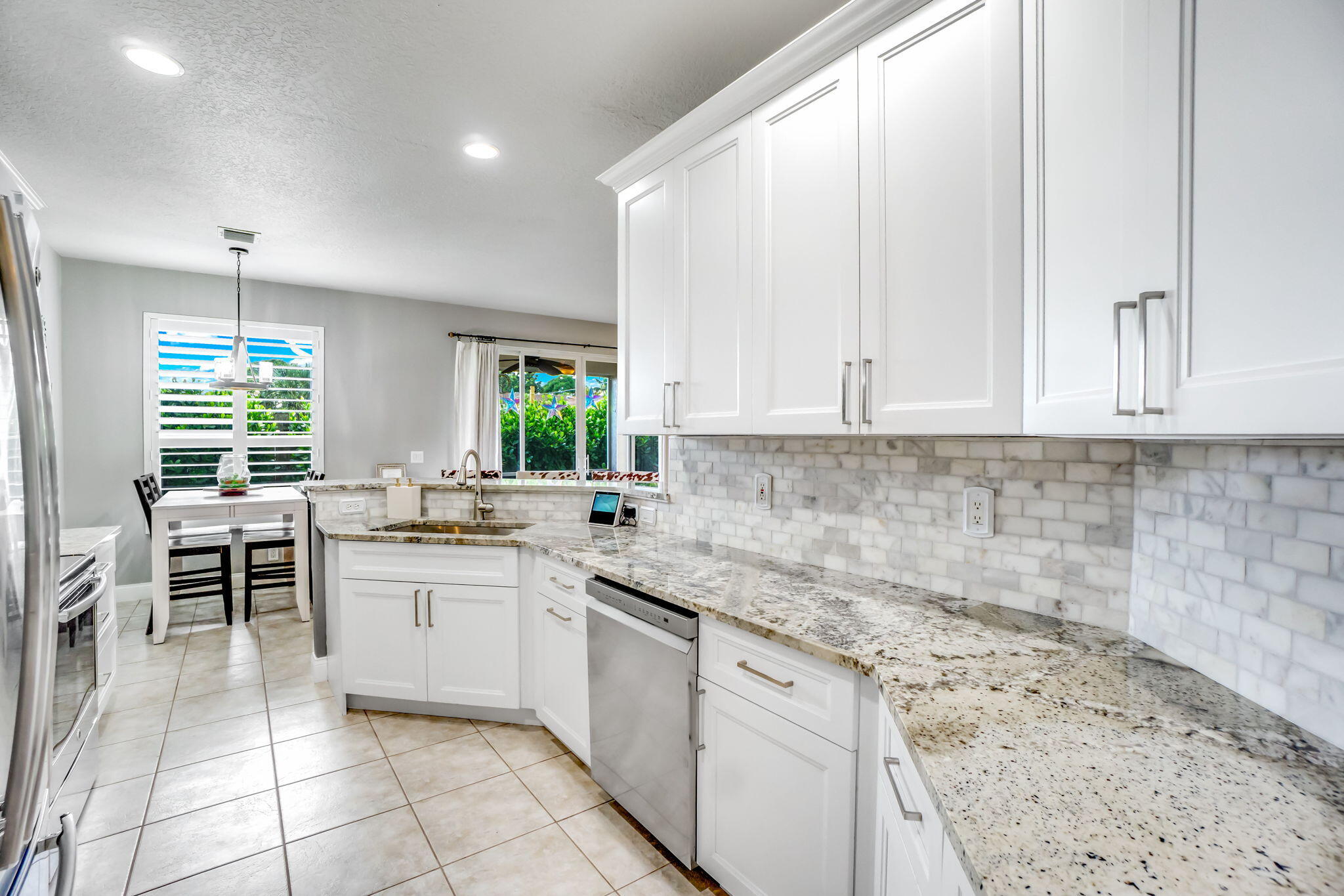 9760 Vineyard Court Boca Raton, FL 33428 - Photo 22 of 75 a kitchen with a sink and cabinets