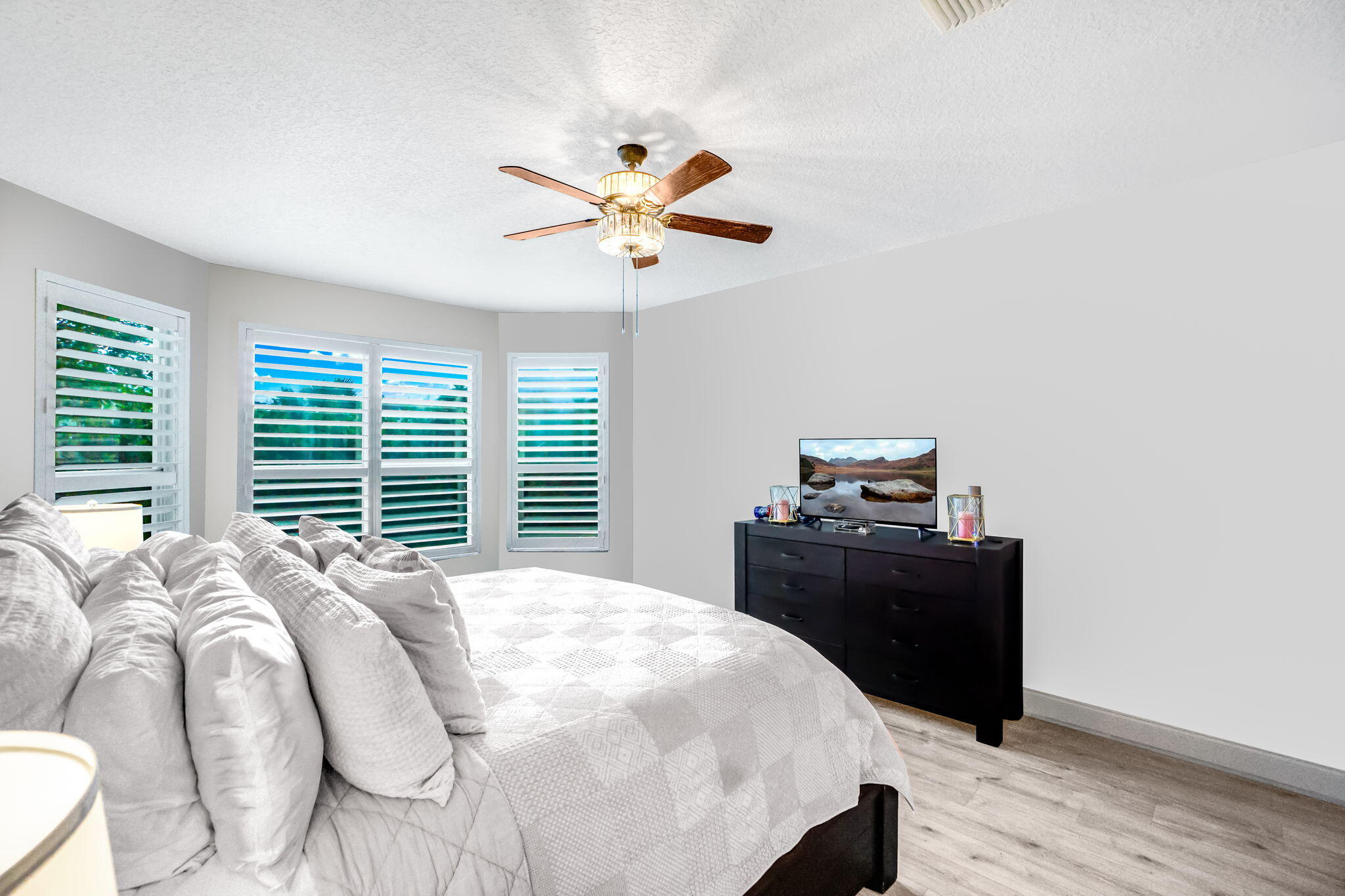 9760 Vineyard Court Boca Raton, FL 33428 - Photo 30 of 75 a bedroom with a bed and a chandelier