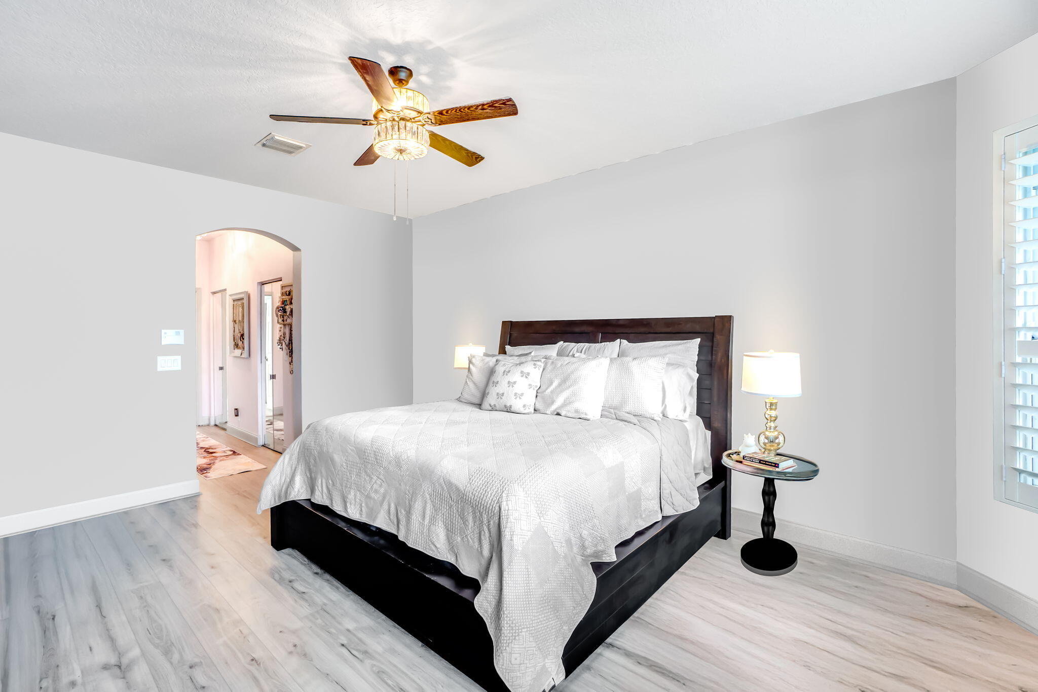 9760 Vineyard Court Boca Raton, FL 33428 - Photo 32 of 75 a bedroom with a bed and a chandelier