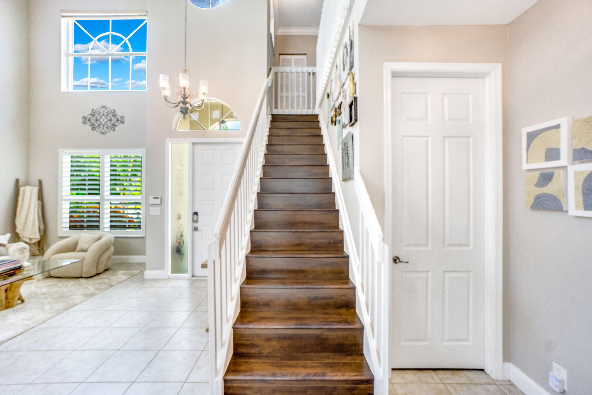 9760 Vineyard Court Boca Raton, FL 33428 - Photo 36 of 75 a view of a hallway with wooden floor and windows