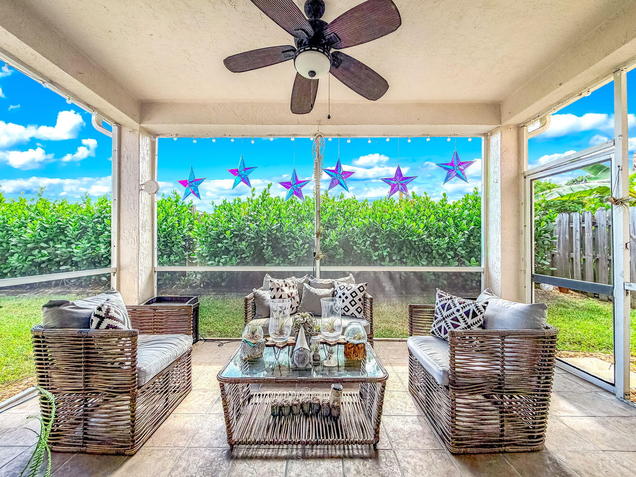 9760 Vineyard Court Boca Raton, FL 33428 - Photo 48 of 75 a living room with patio furniture and a floor to ceiling window