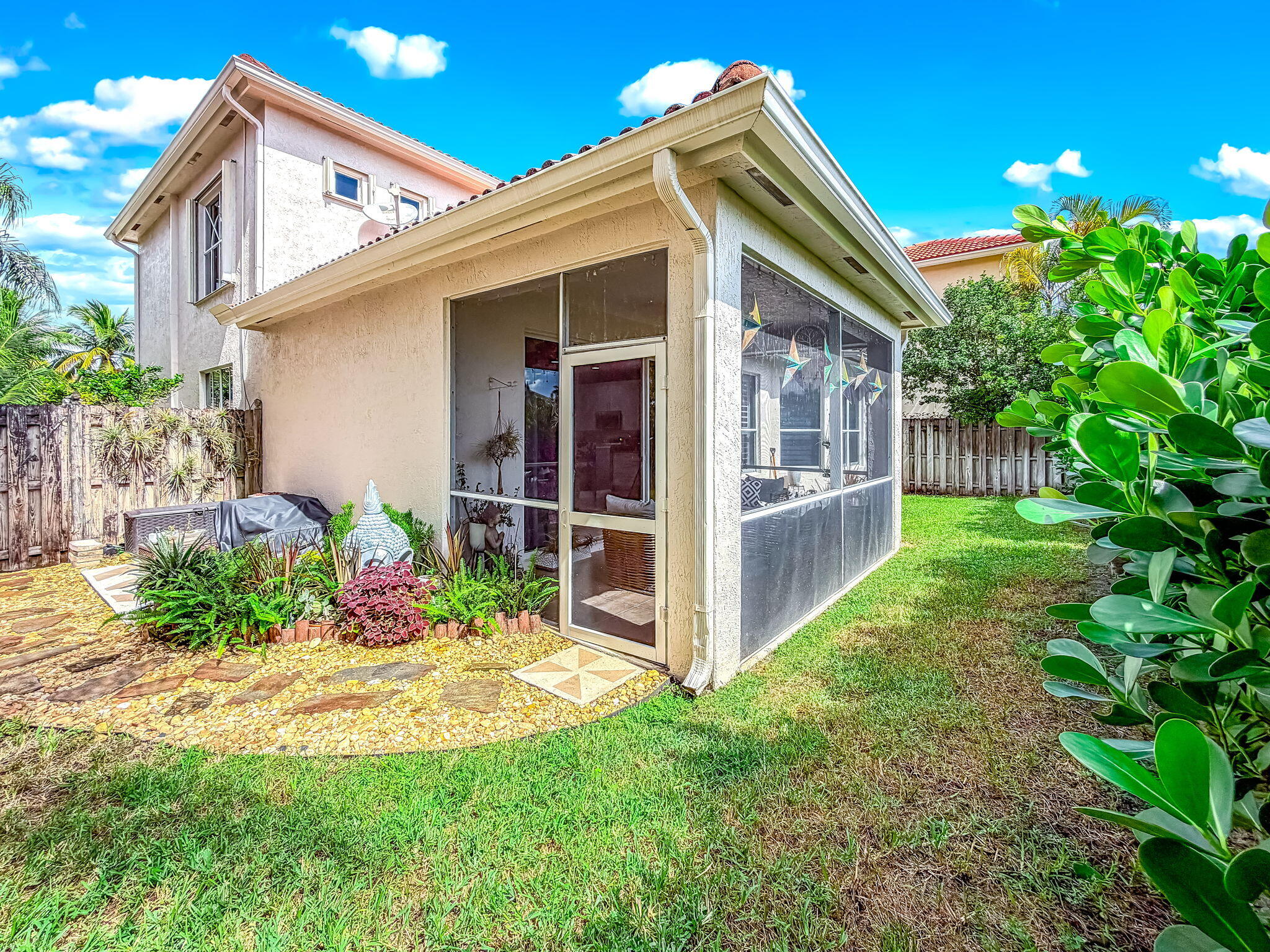 9760 Vineyard Court Boca Raton, FL 33428 - Photo 53 of 75 a view of a house with a yard and potted plants