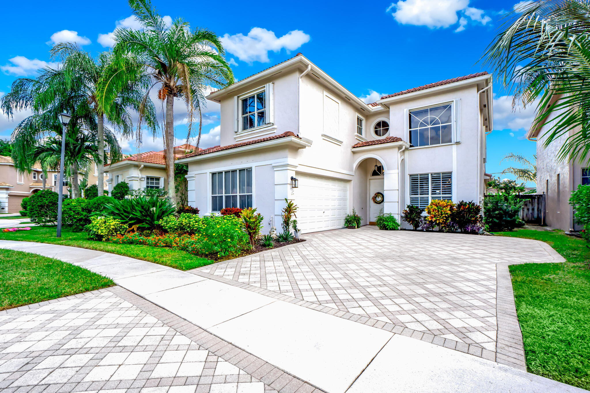 9760 Vineyard Court Boca Raton, FL 33428 - Photo 71 of 75 a front view of a house with a garden