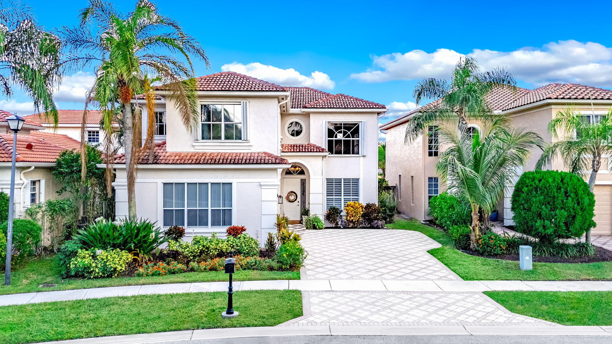 9760 Vineyard Court Boca Raton, FL 33428 - Photo 72 of 75 a front view of a house with a garden and plants