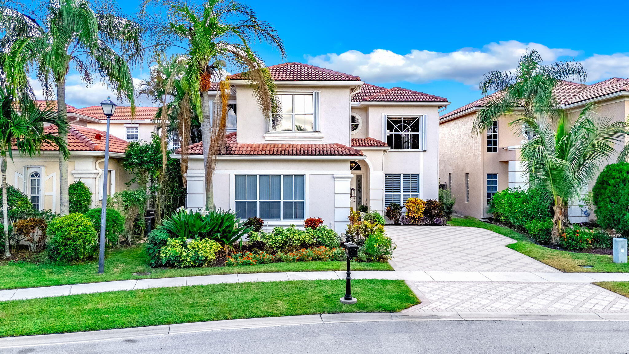 9760 Vineyard Court Boca Raton, FL 33428 - Photo 73 of 75 a front view of a house with a garden and plants