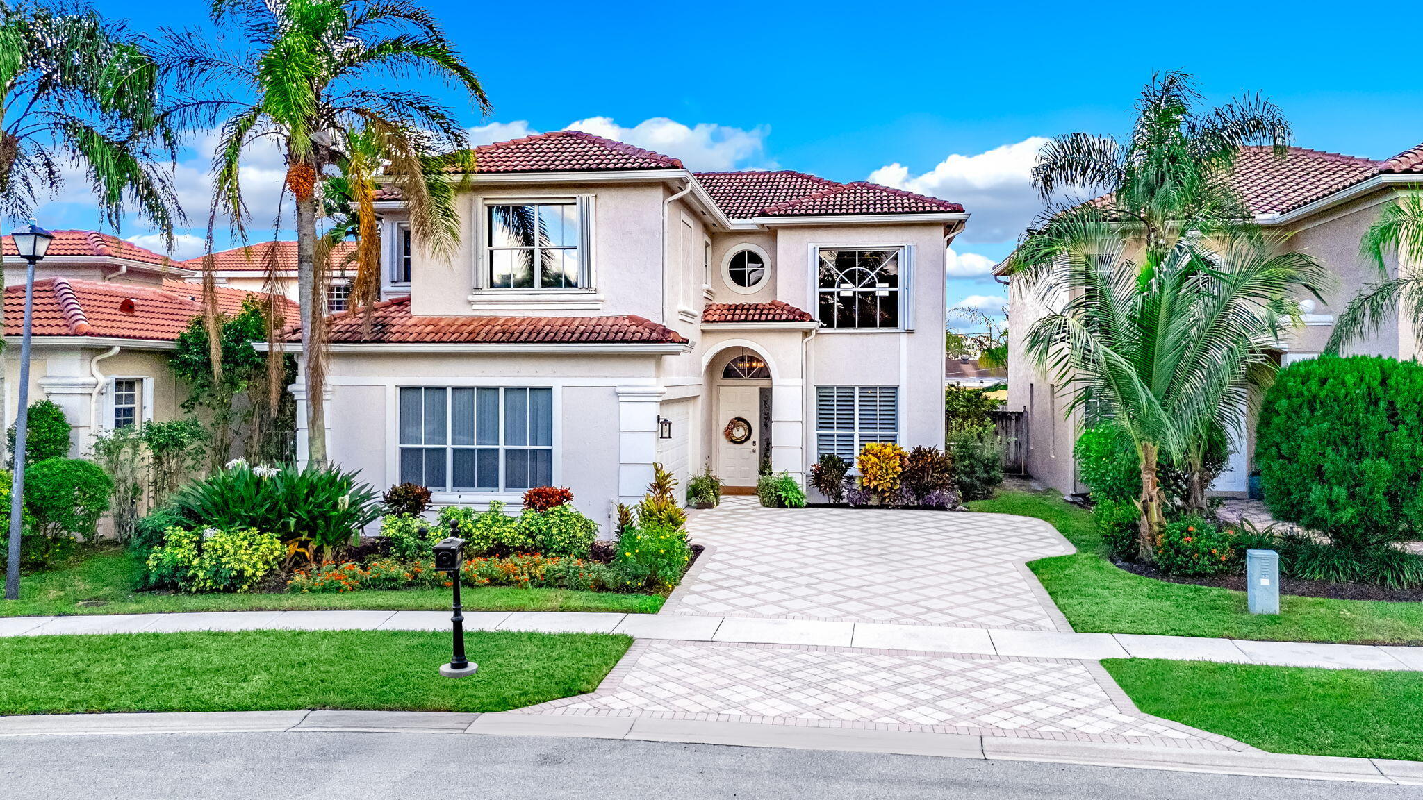 9760 Vineyard Court Boca Raton, FL 33428 - Photo 74 of 75 a front view of a house with a yard and potted plants