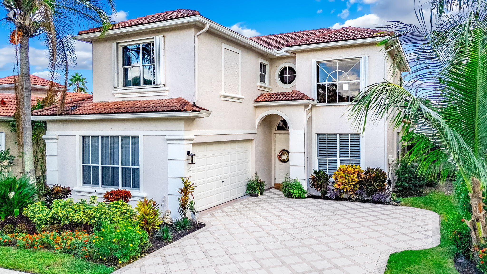 9760 Vineyard Court Boca Raton, FL 33428 - Photo 75 of 75 a view of a white house with large windows and plants