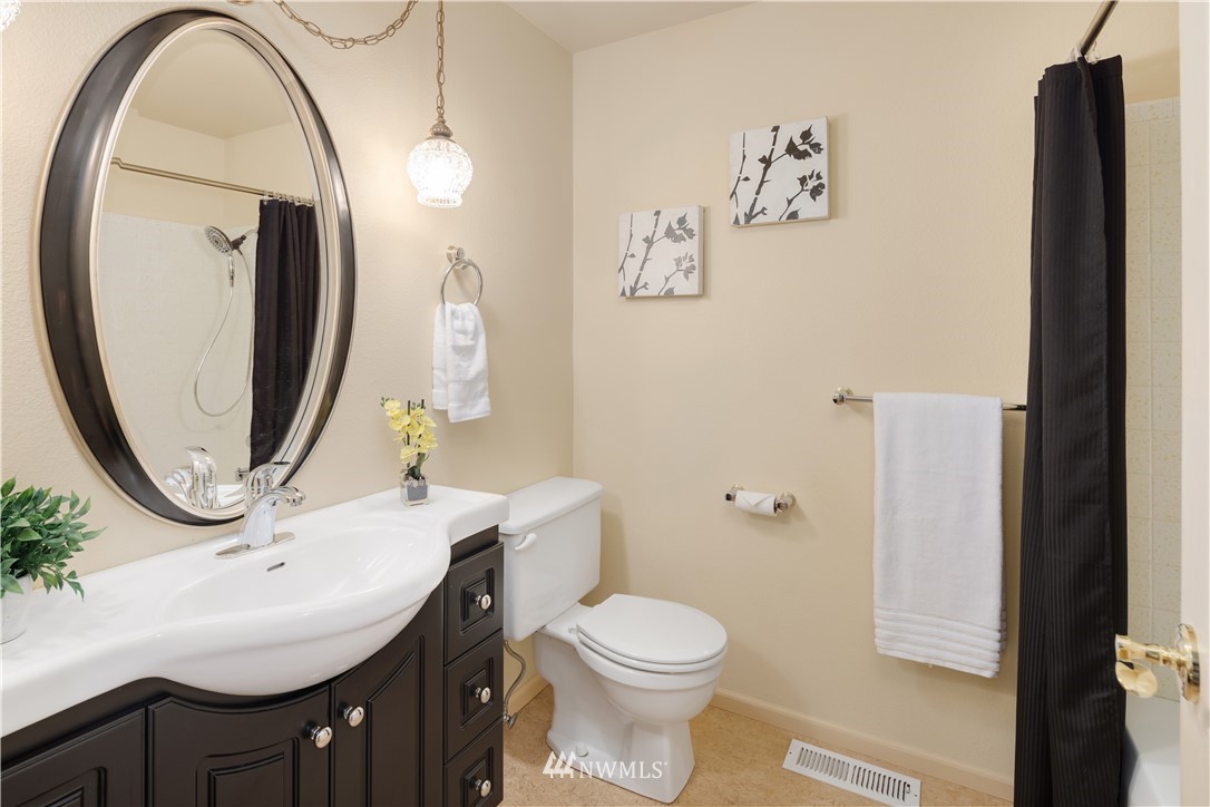 22918 38th Avenue Southeast Bothell, WA 98021 - Photo 11 of 28 a bathroom with a sink a toilet and a mirror