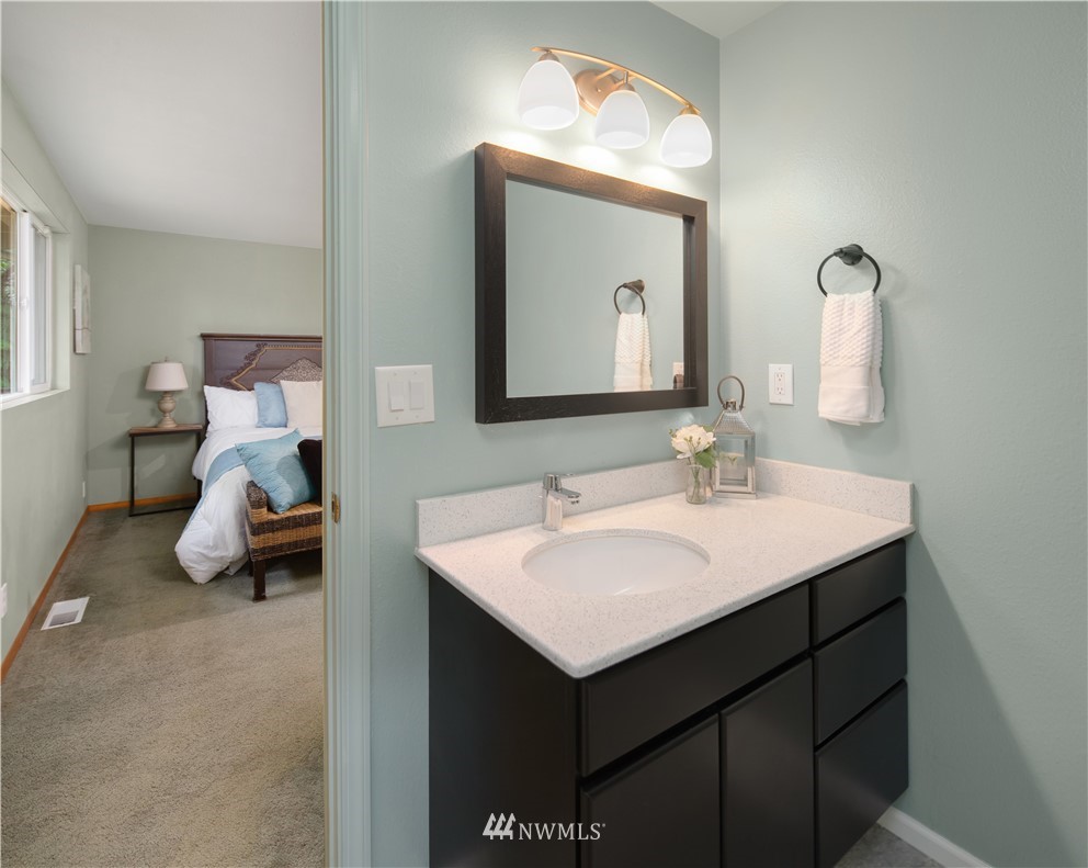 22918 38th Avenue Southeast Bothell, WA 98021 - Photo 13 of 28 a en suite bathroom with a sink and a mirror