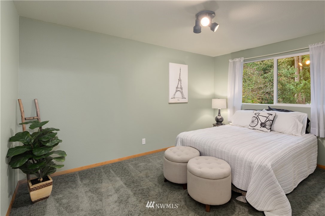 22918 38th Avenue Southeast Bothell, WA 98021 - Photo 16 of 28 a bedroom with a bed and a potted plant