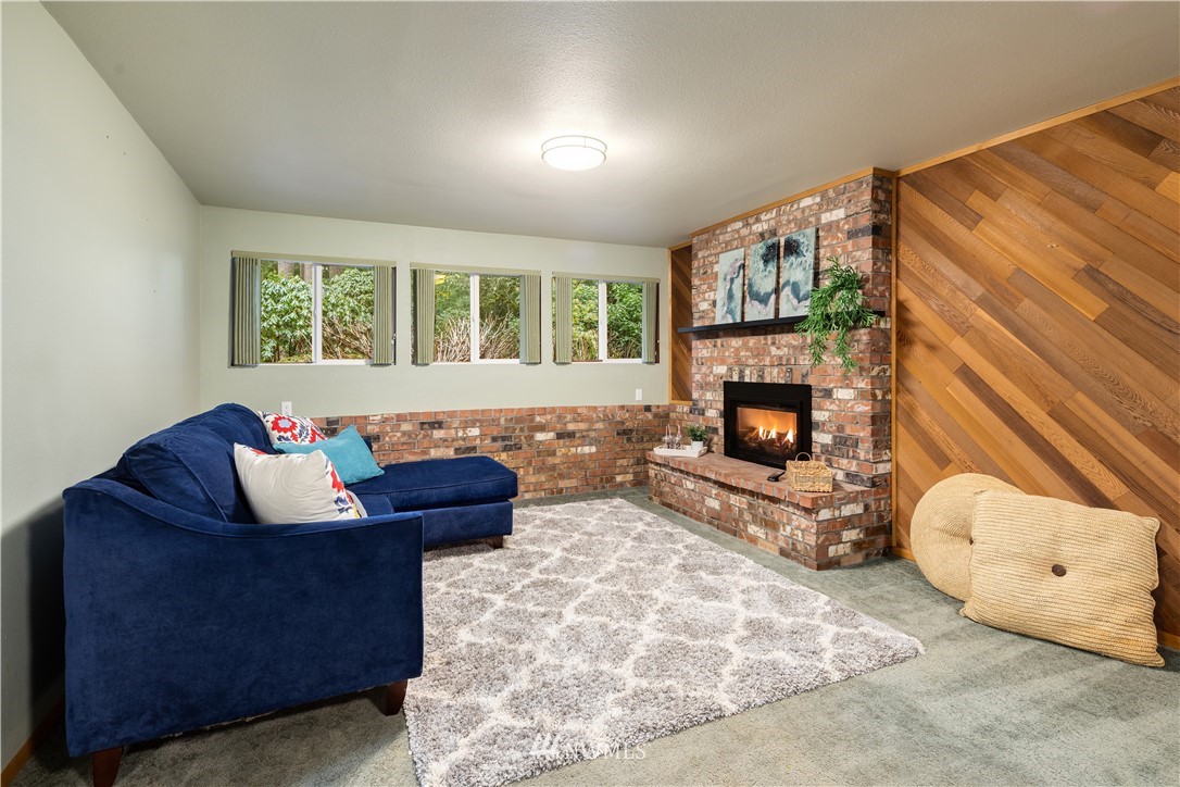22918 38th Avenue Southeast Bothell, WA 98021 - Photo 17 of 28 a living room with furniture and a fireplace