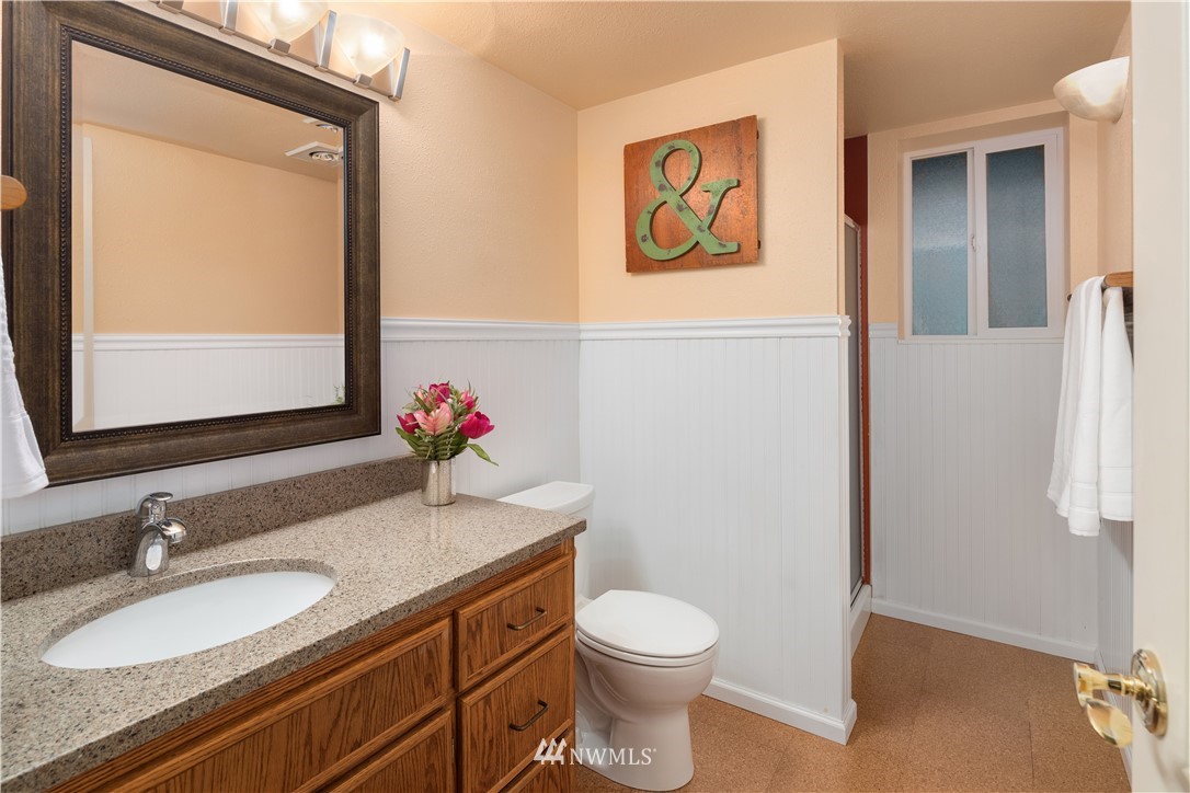 22918 38th Avenue Southeast Bothell, WA 98021 - Photo 21 of 28 a bathroom with a granite countertop sink mirror vanity and toilet