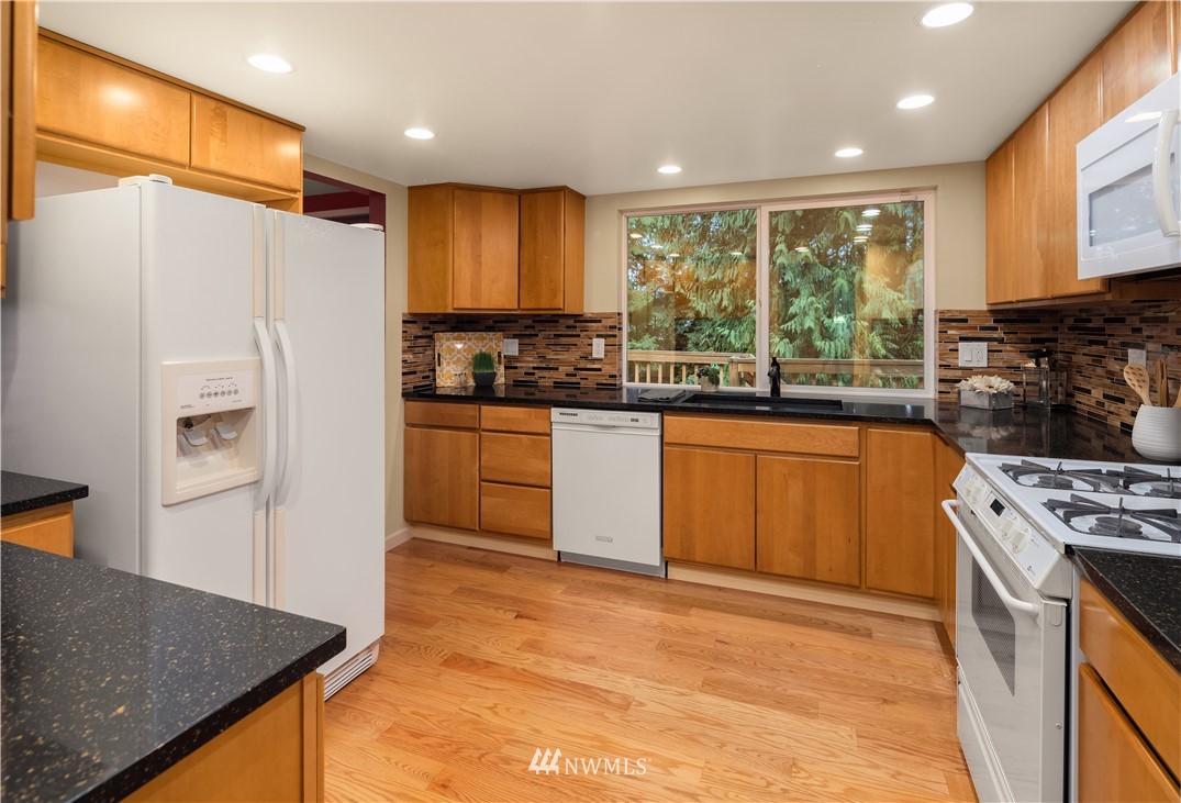 22918 38th Avenue Southeast Bothell, WA 98021 - Photo 8 of 28 a kitchen with stainless steel appliances granite countertop a stove a sink and a refrigerator