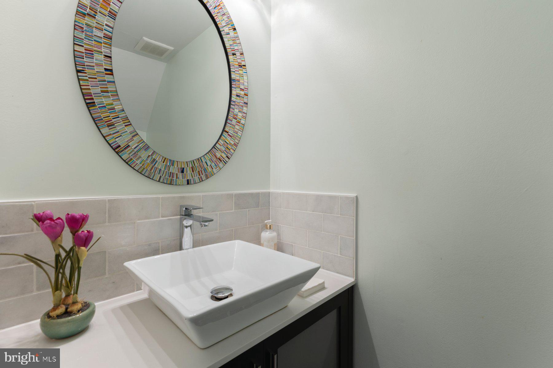 6028 Sweet Dale Court Springfield, VA 22152 - Photo 14 of 29 a bathroom with a sink a mirror and a potted plant