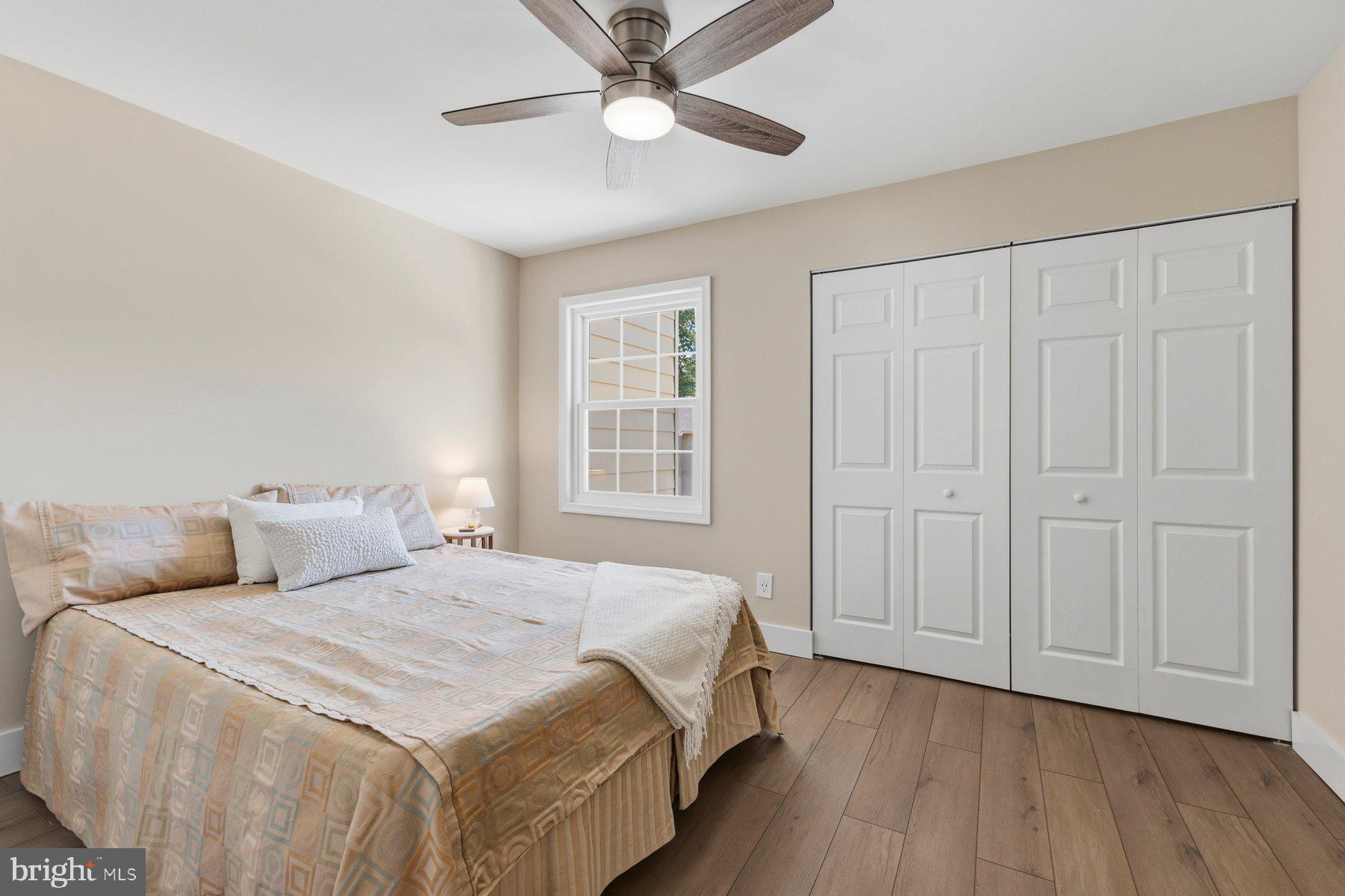 6028 Sweet Dale Court Springfield, VA 22152 - Photo 15 of 29 a bedroom with a large bed and a chandelier fan