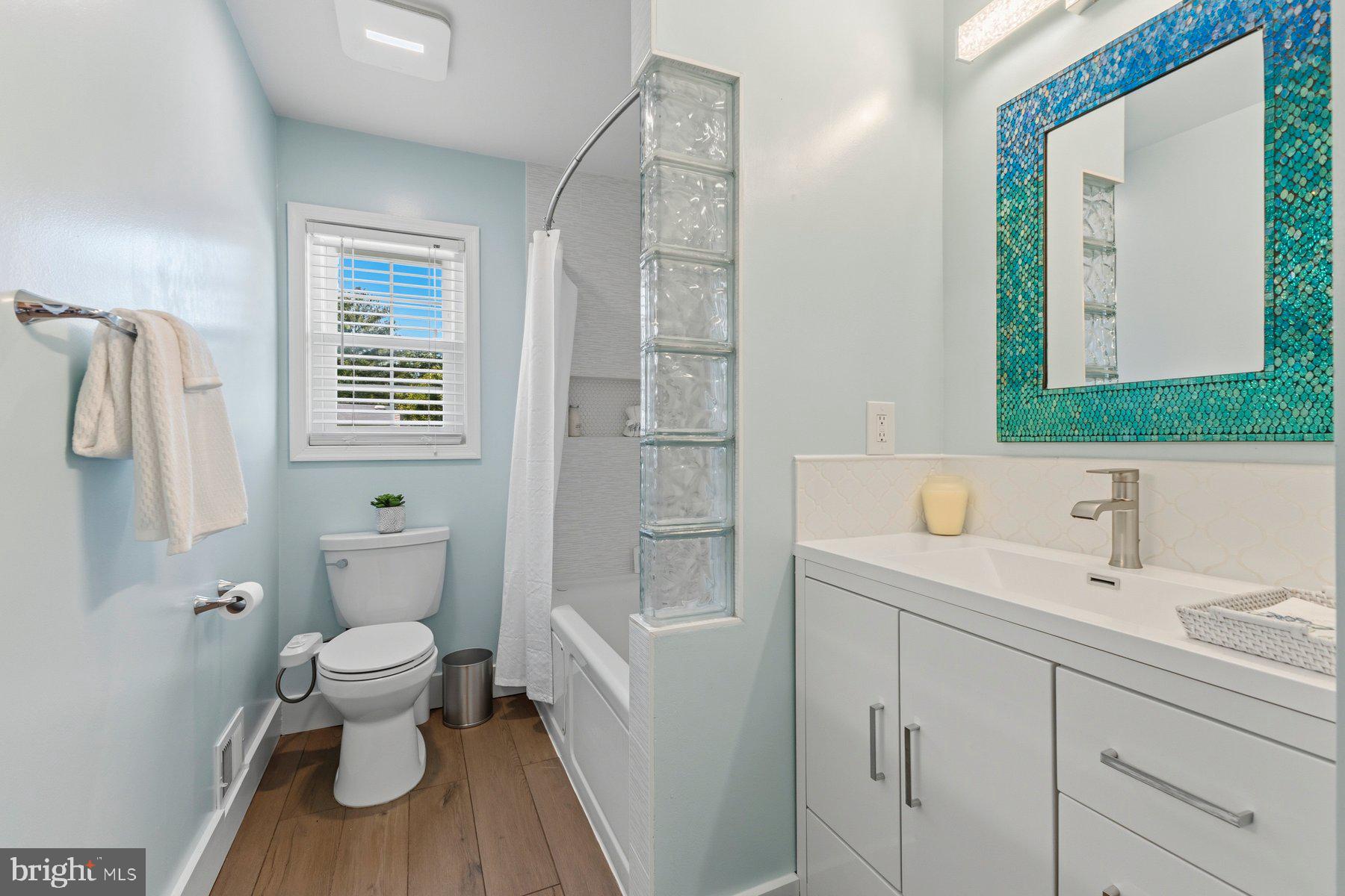 6028 Sweet Dale Court Springfield, VA 22152 - Photo 17 of 29 a bathroom with a sink a toilet and shower