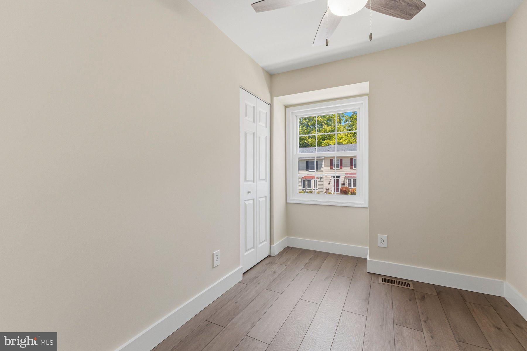 6028 Sweet Dale Court Springfield, VA 22152 - Photo 18 of 29 a view of an empty room with wooden floor and a window