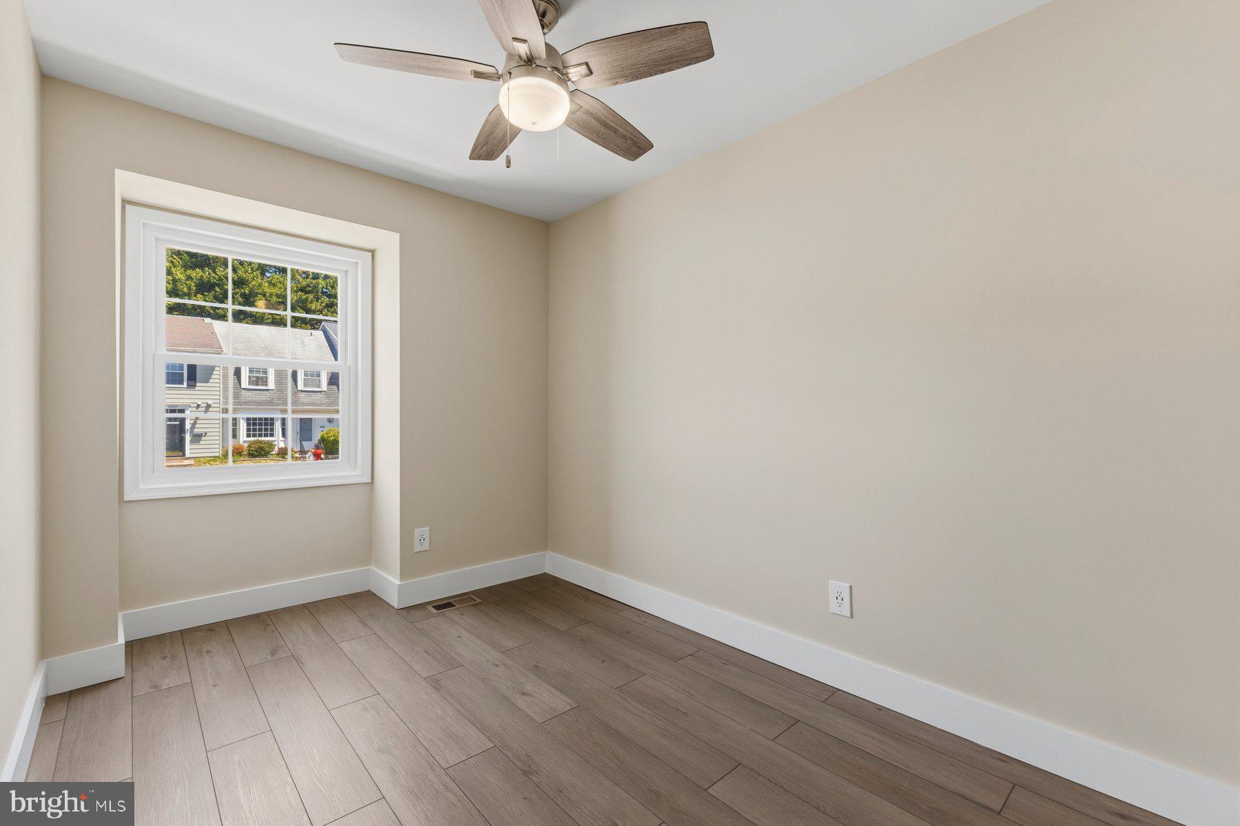 6028 Sweet Dale Court Springfield, VA 22152 - Photo 19 of 29 an empty room with wooden floor fan and windows