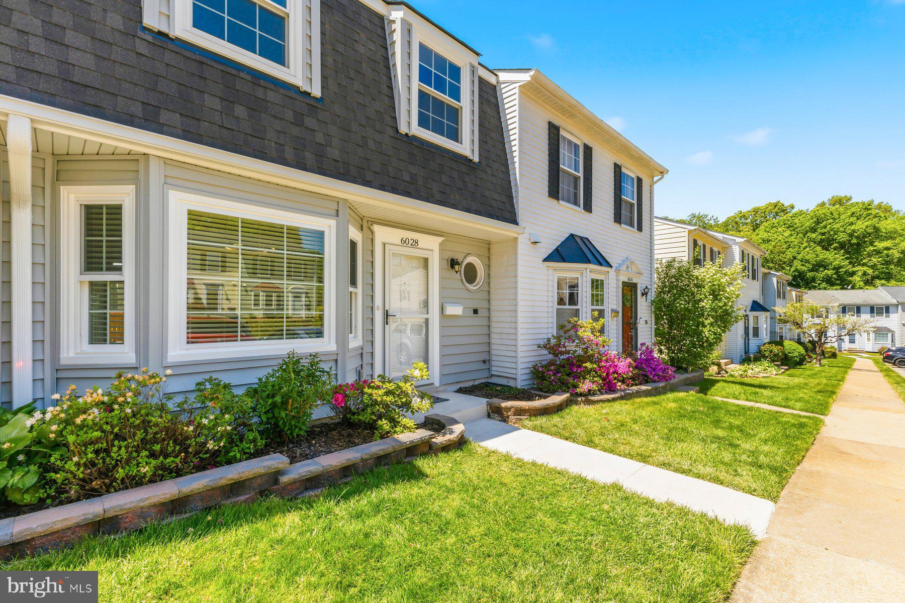 6028 Sweet Dale Court Springfield, VA 22152 - Photo 2 of 29 a front view of a house with a yard and porch