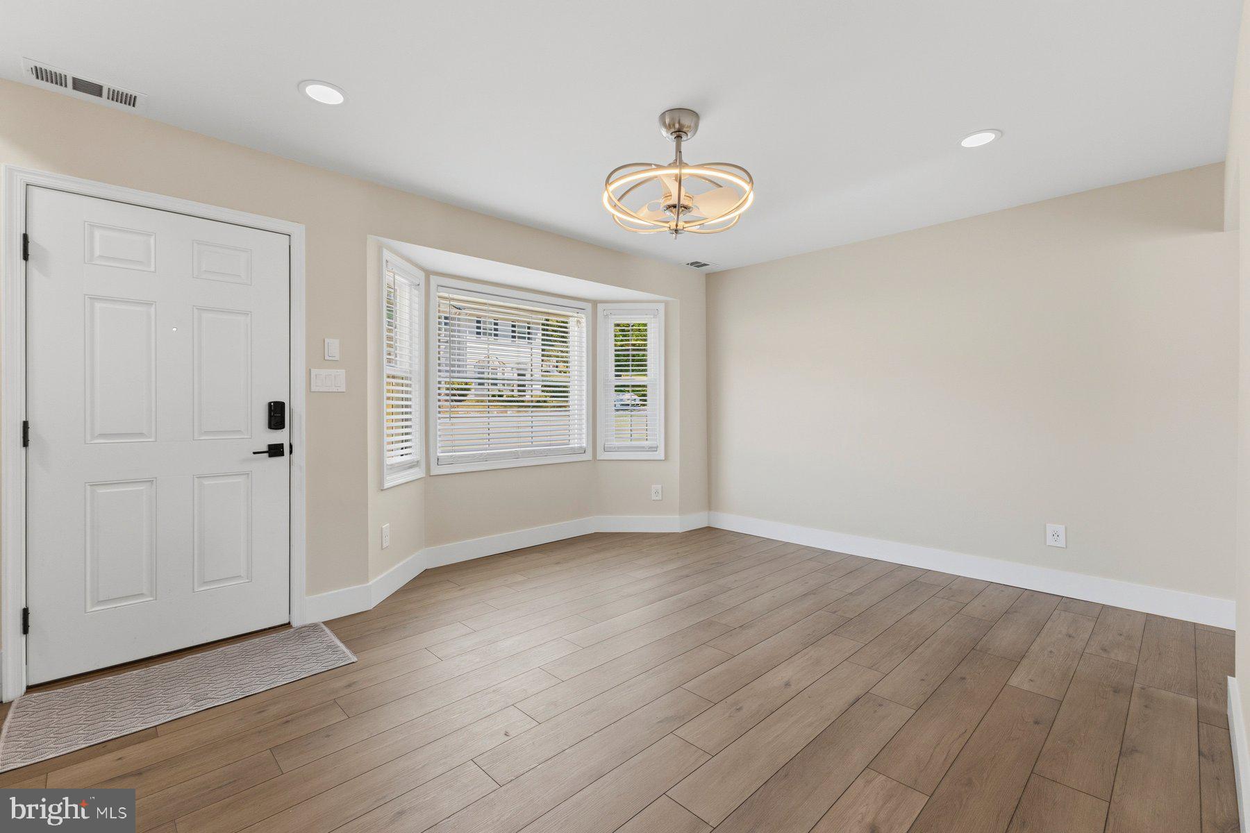 6028 Sweet Dale Court Springfield, VA 22152 - Photo 5 of 29 an empty room with wooden floor and windows