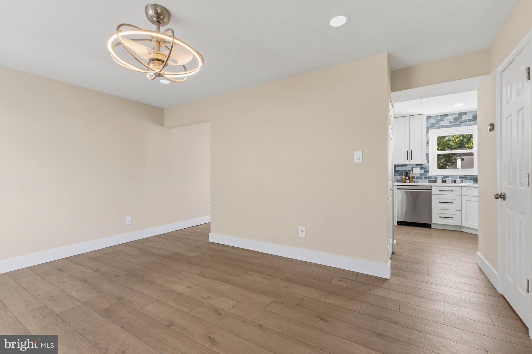 6028 Sweet Dale Court Springfield, VA 22152 - Photo 6 of 29 a view of a kitchen with a sink dishwasher and wooden floor