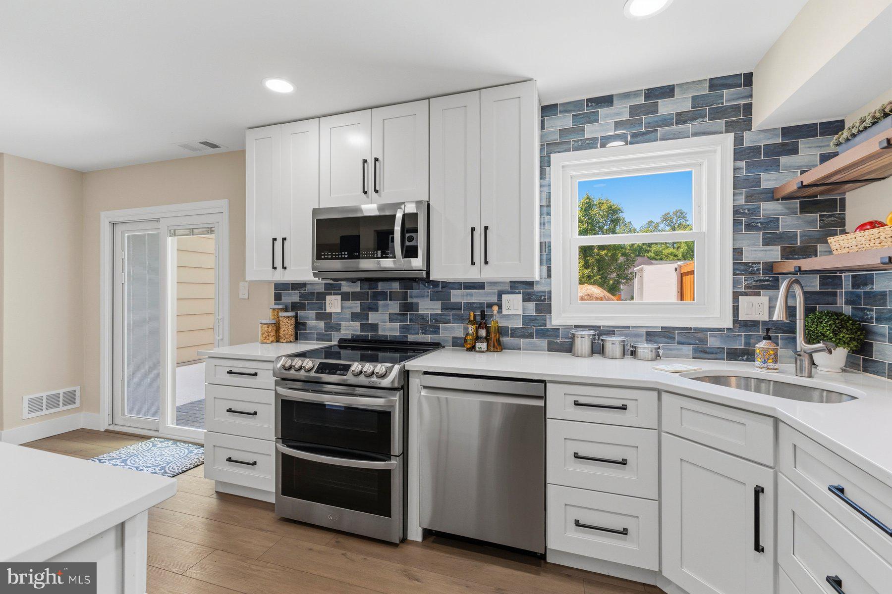 6028 Sweet Dale Court Springfield, VA 22152 - Photo 8 of 29 a kitchen with white cabinets appliances and a window