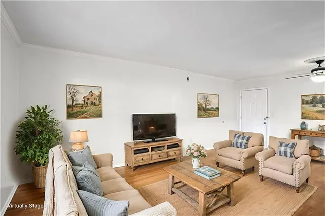 a living room with furniture and a flat screen tv