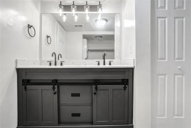 a bathroom with a sink a vanity a mirror and a bathtub